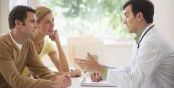 Couple consulting with functional medicine doctor about hormone imbalance and fertility treatments