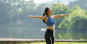 Healthy woman enjoying vitality and outdoor exercise for holistic stress management